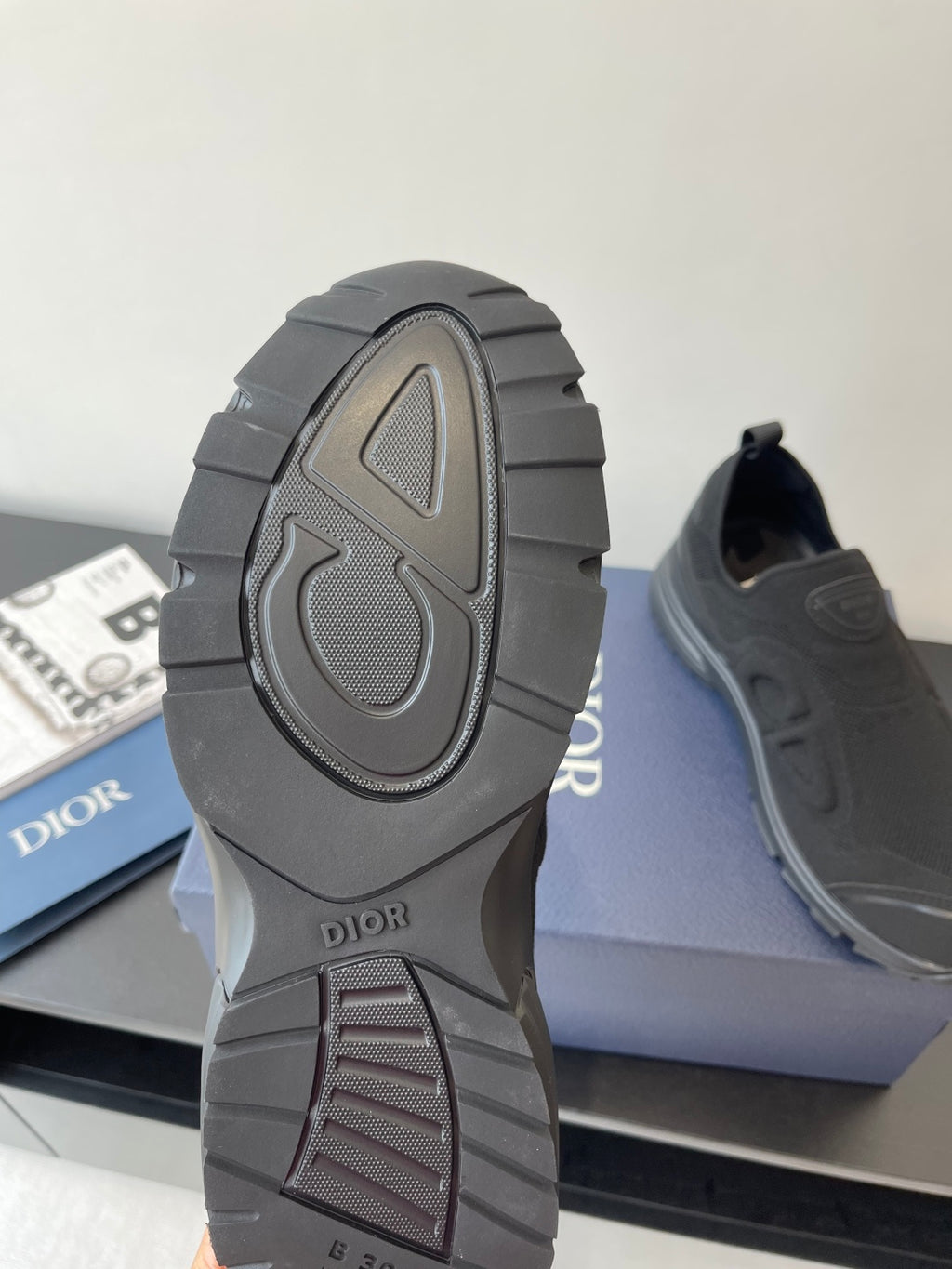 Dior sneaker outsole and heel, dark gray rubber tread with 'Dior' logo