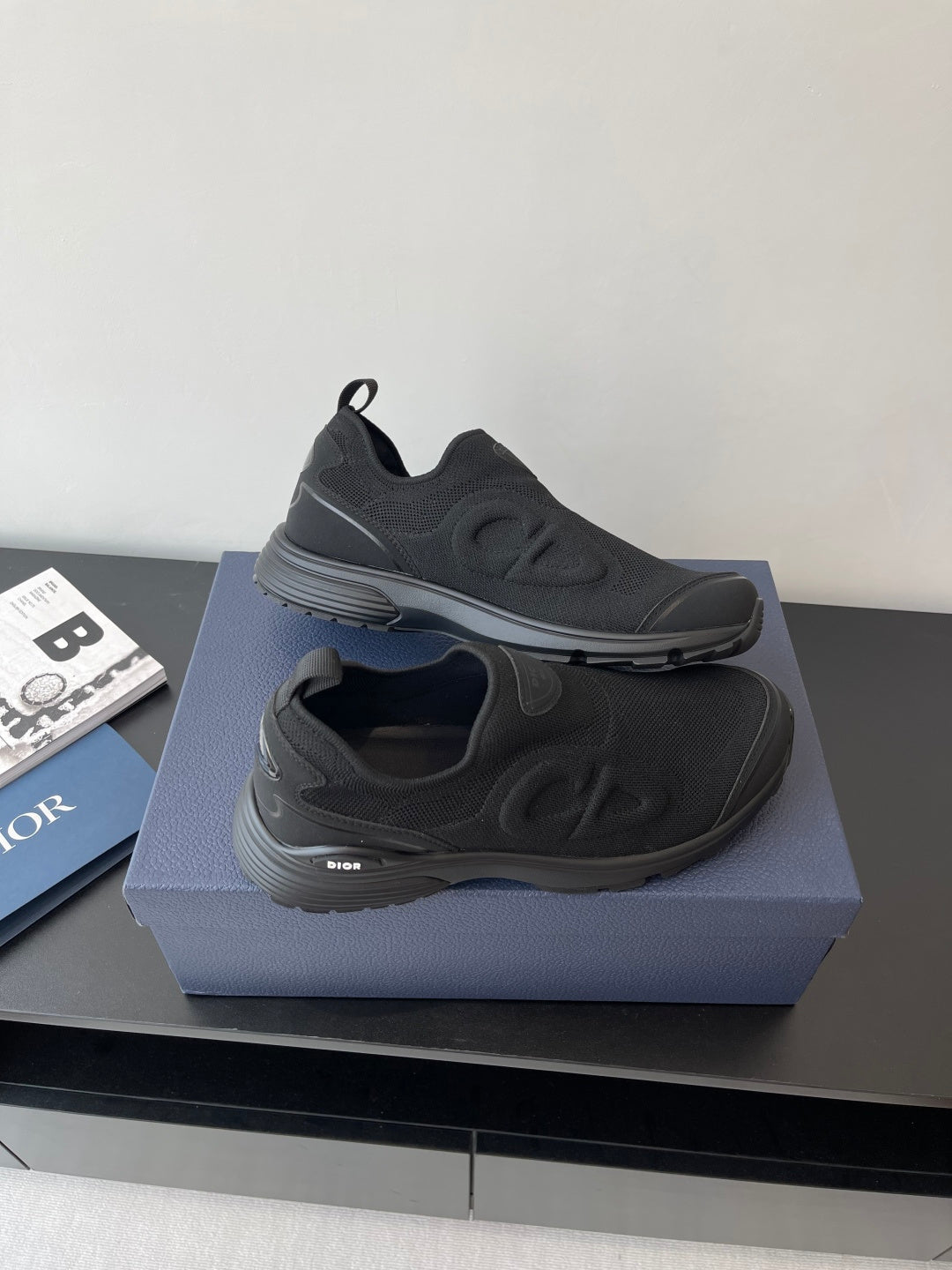 Dior slip-on sneakers, dark gray, sculpted sole with side logo, pair on display