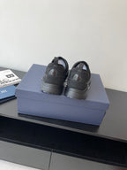 Pair of Dior slip-on sneakers, dark gray with low stacked sole and pull tabs