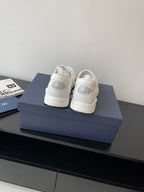 Back view of white Dior low-top sneakers with rear logo detailing