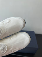 White Dior sneakers outsole and toe detail, textured knit upper and stitched sole