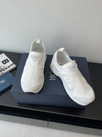 Pair of white Dior slip-on sneakers with padded collars and textured uppers