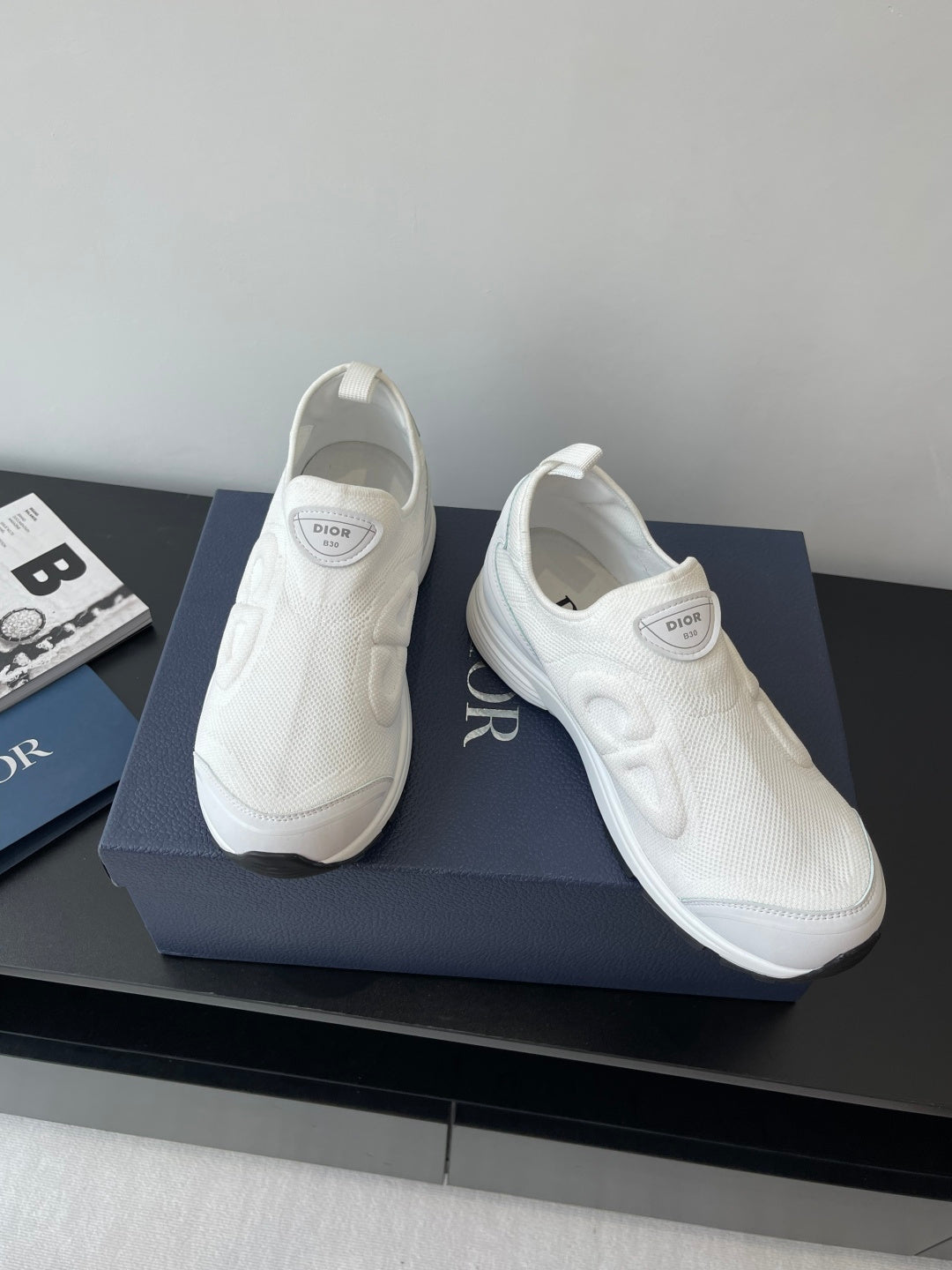 Pair of white Dior slip-on sneakers with padded collars and textured uppers