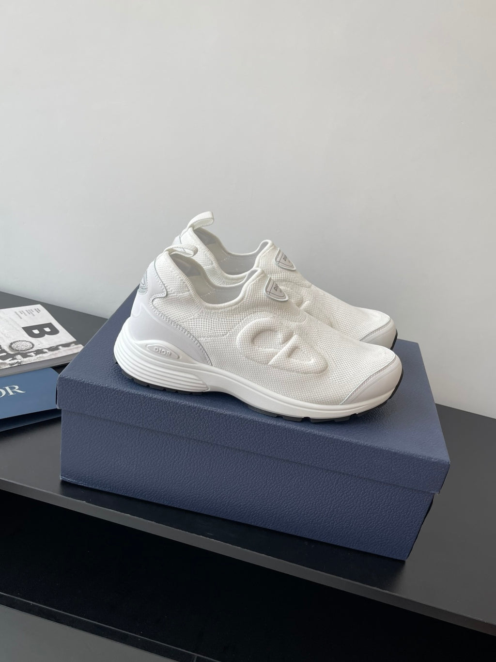 White Dior sporty sneakers with wavy side logo detailing and lace-free design