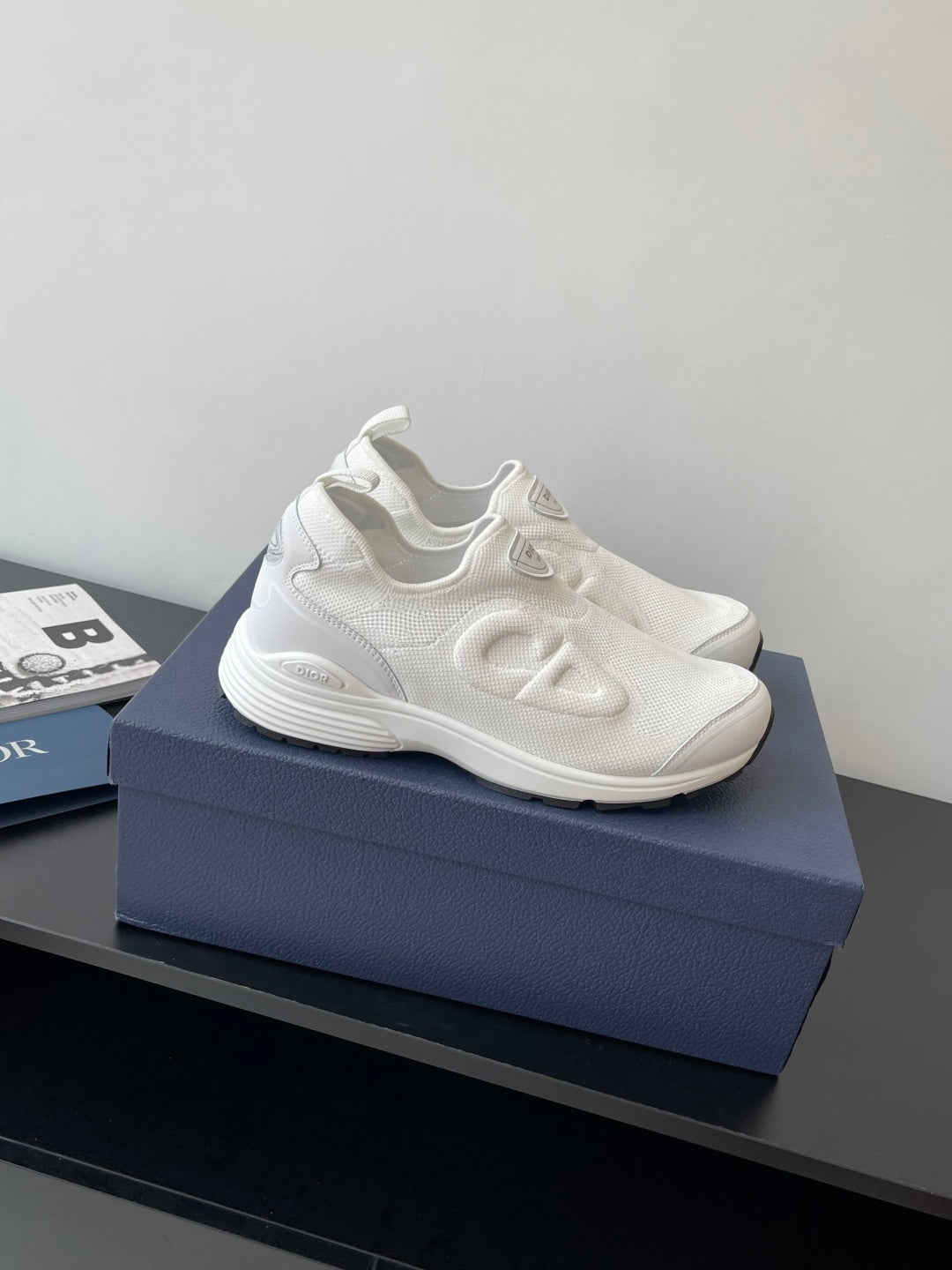 White Dior sporty sneakers with wavy side logo detailing and lace-free design