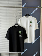 Short-sleeve T-shirts in white and black on hangers, each with chest bird embroidery