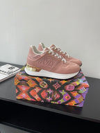 Women's Louis Vuitton sneakers, blush pink leather with white laces and side embossing.