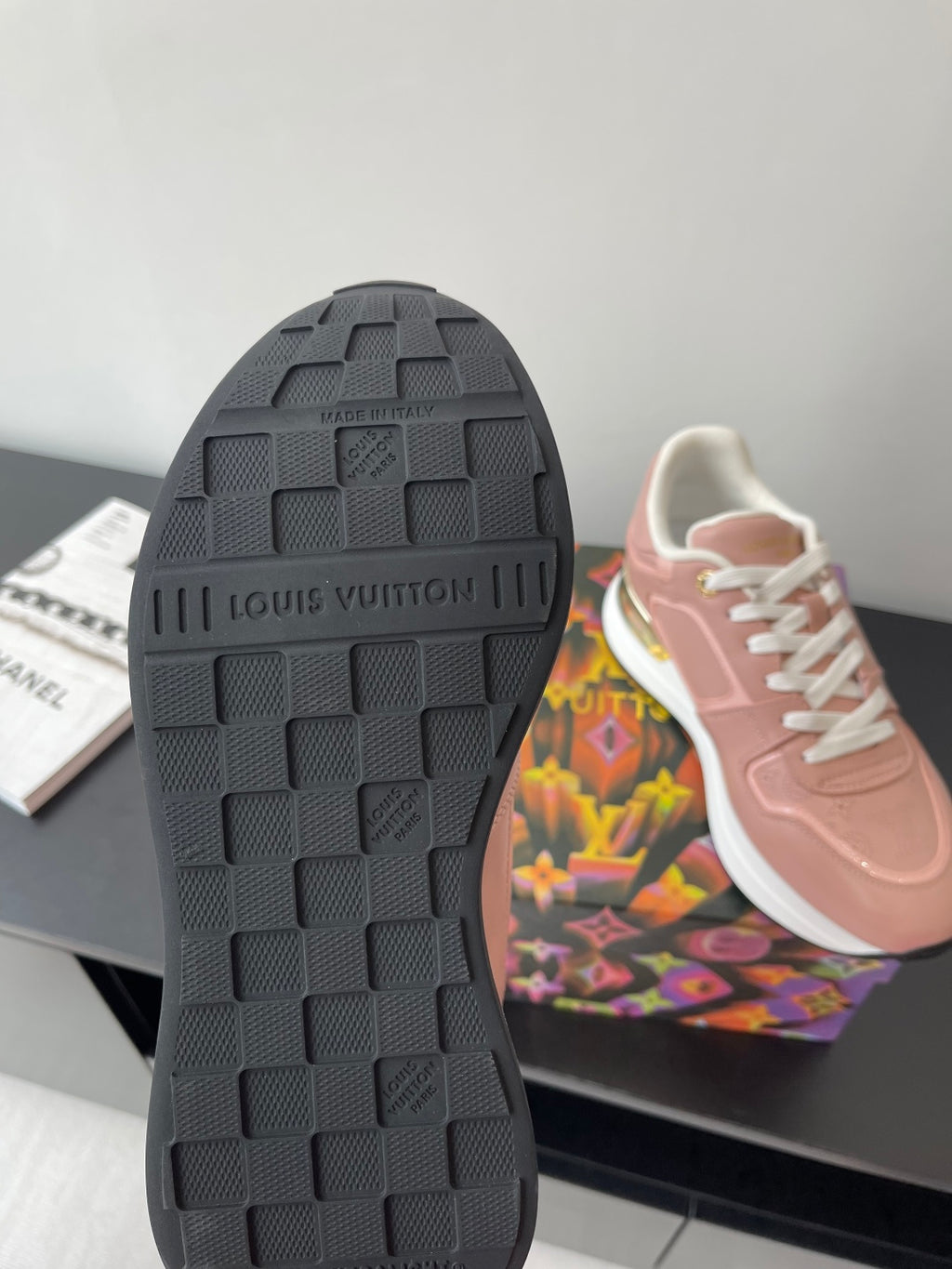 Women's Louis Vuitton sneakers outsole view, dark rubber tread with brand lettering.