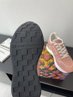 Women's Louis Vuitton sneakers outsole view, dark rubber tread with brand lettering.