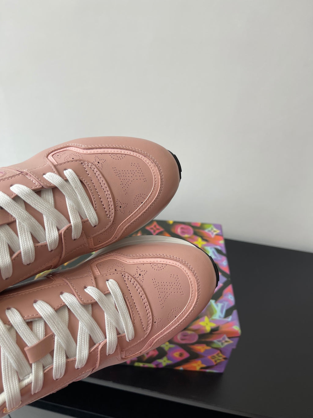 Women's Louis Vuitton sneakers, blush pink leather toe with white lace eyelets.