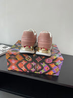 Women's Louis Vuitton sneakers, back view with gold heel trim and white soles.