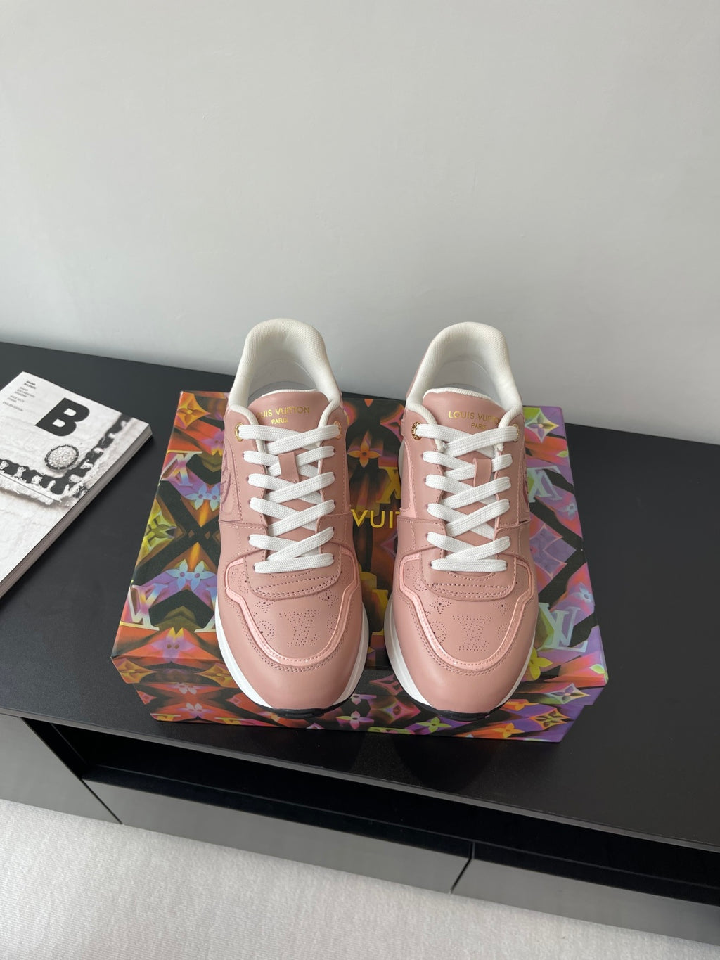 Women's Louis Vuitton sneakers, blush pink with white laces and embossed logo.