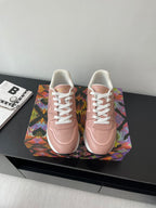 Women's Louis Vuitton sneakers, blush pink with white laces and embossed logo.