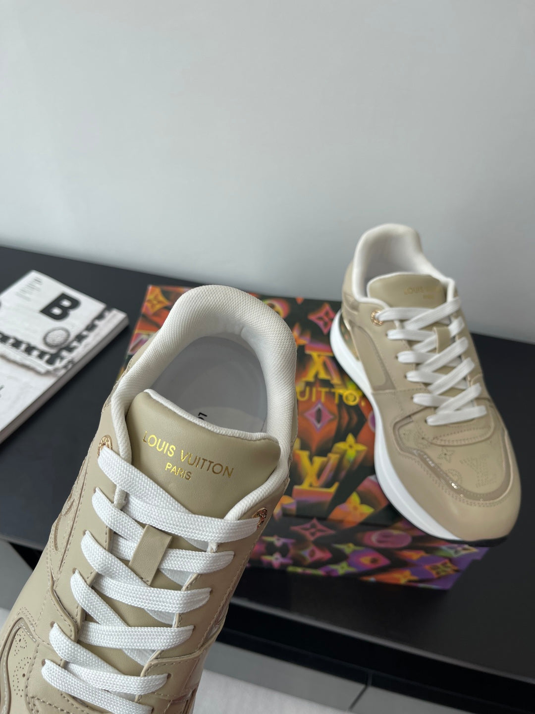 Louis Vuitton ladies sneakers, light beige with white laces and 'Louis Vuitton Paris' logo.