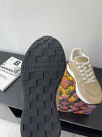 Louis Vuitton ladies sneaker outsole, dark textured rubber tread with brand embossing.