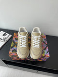 Louis Vuitton ladies low-top sneakers, light beige with white laces and stitched logo.