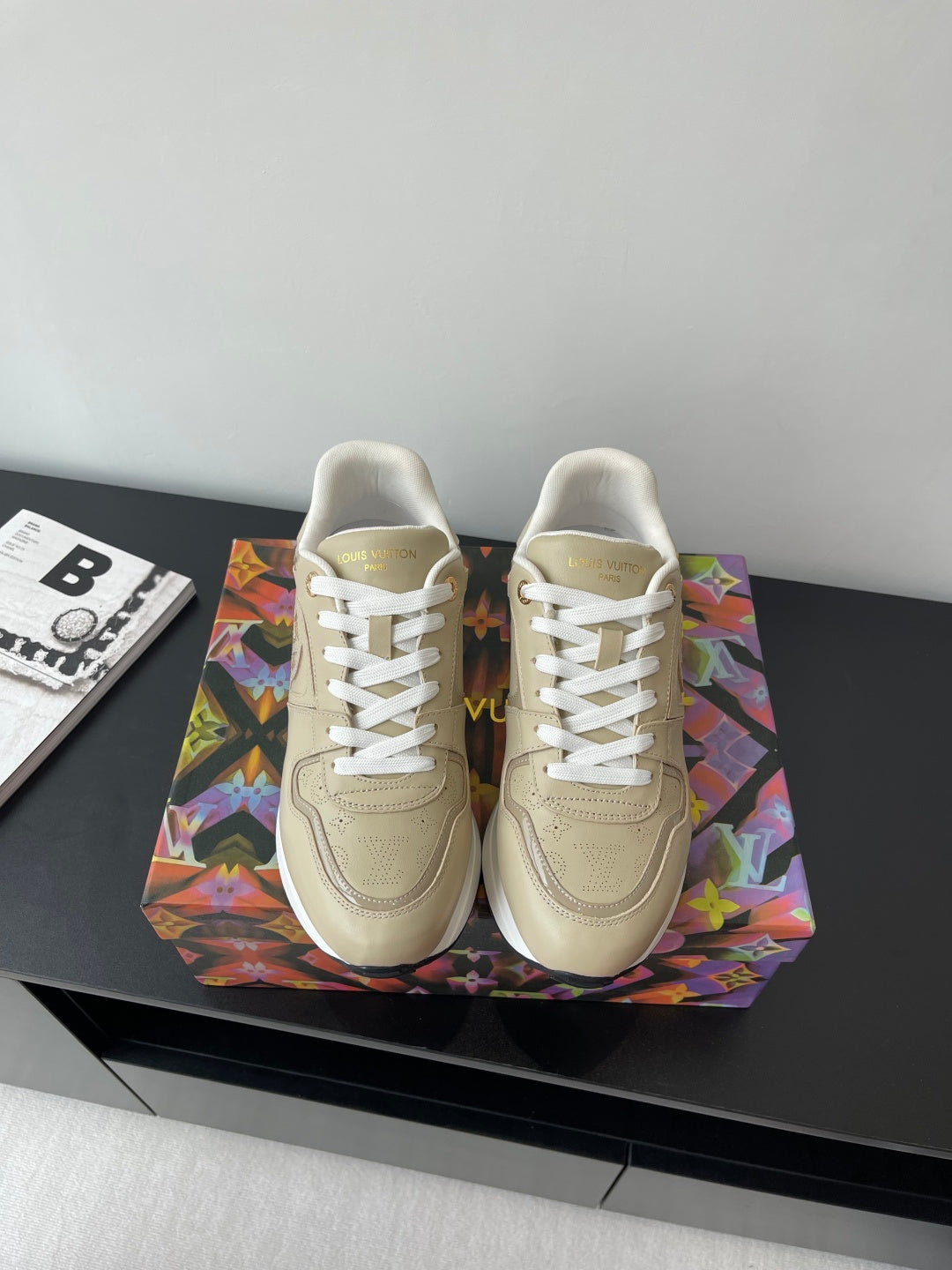 Louis Vuitton ladies low-top sneakers, light beige with white laces and stitched logo.