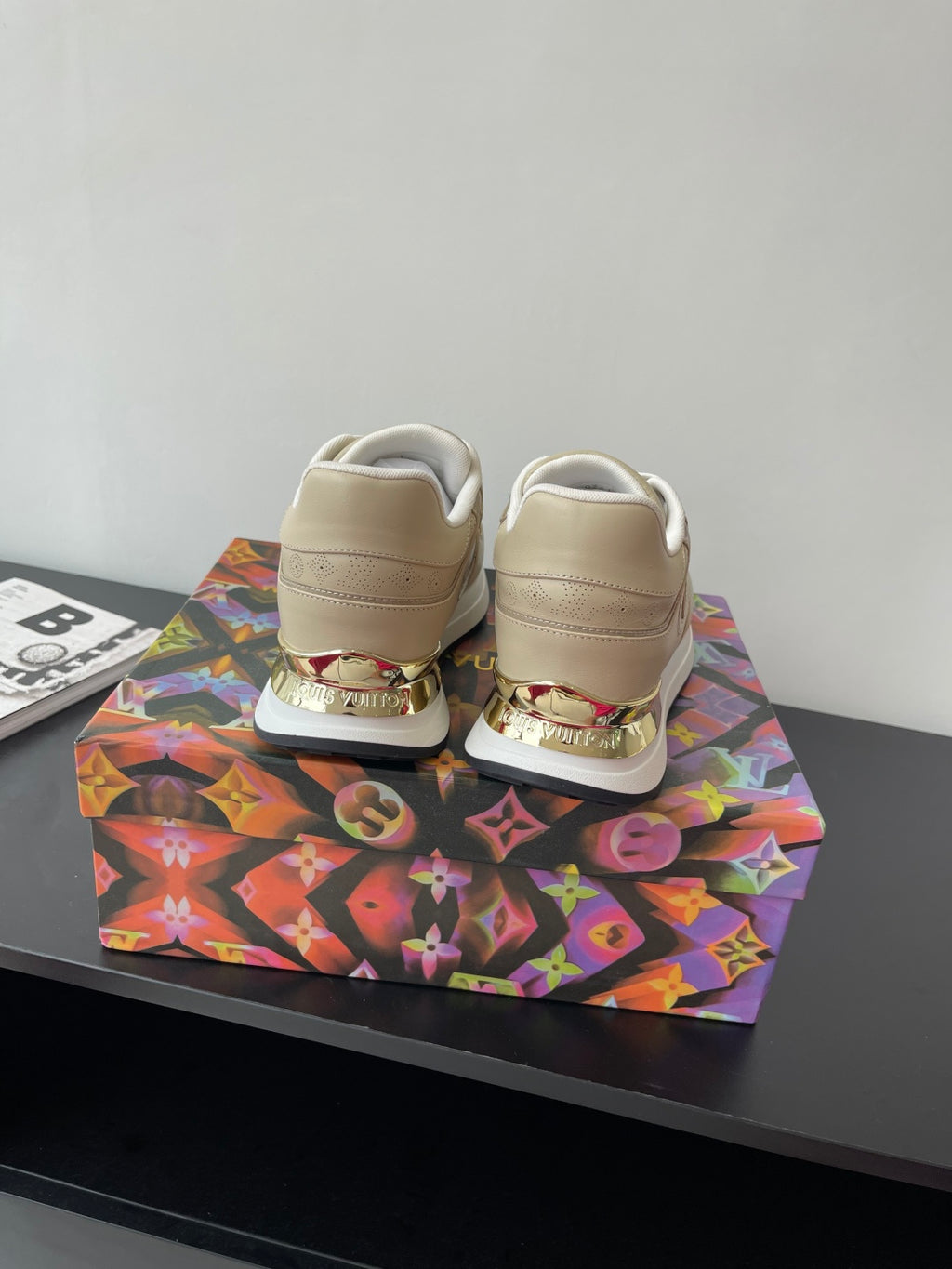 Louis Vuitton ladies sneakers, light beige with white laces, rear heel branding detail.