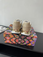 Louis Vuitton ladies sneakers, light beige with white laces, rear heel branding detail.
