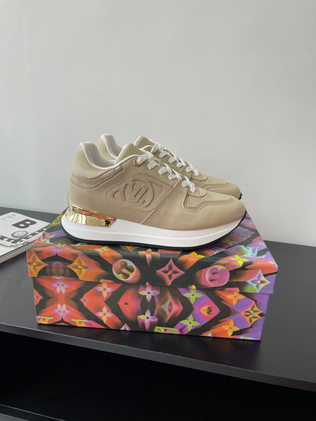 Louis Vuitton ladies low-top sneakers, light beige with white laces and chunky sole.