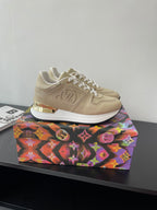Louis Vuitton ladies low-top sneakers, light beige with white laces and chunky sole.