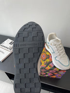 Shoe outsole view: dark tread sole with white and light blue upper