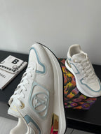 White and light blue high-profile sneakers with gold heel detail and lace-up front