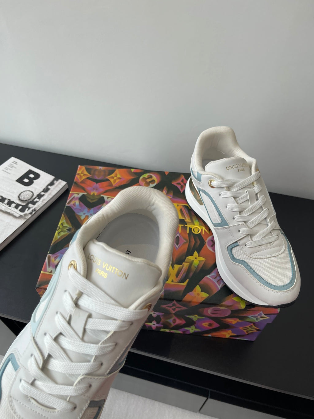 White and light blue lace-up sneakers shown from the toe and tongue