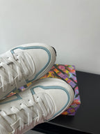 Close-up of white and light blue sneaker side mesh and lace-up area