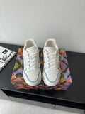 White and light blue lace-up sneakers with gold heel accents and side logo detail