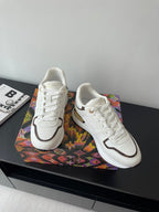 Louis Vuitton ladies sneakers, white lace-up with dark collar trim and gold outsole detail