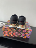 Ladies lace-up sneakers back view, dark upper with gold heel accents and LV branding.