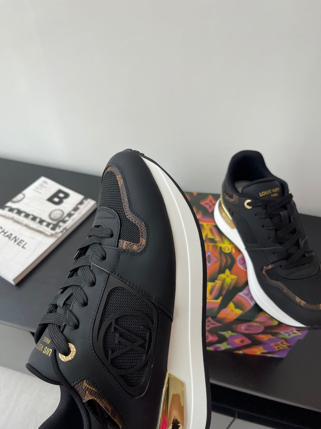 Ladies lace-up sneaker profile, dark upper with white sole and gold-trim heel detail.