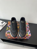 Ladies lace-up sneaker, dark upper with LV logos and multicolor side accents.