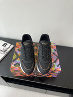 Ladies lace-up sneaker, dark upper with LV logos and multicolor side accents.