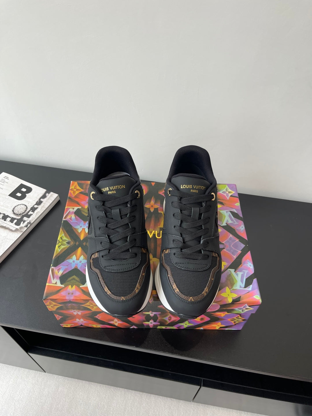 Ladies lace-up sneaker, dark upper with LV logos and multicolor side accents.
