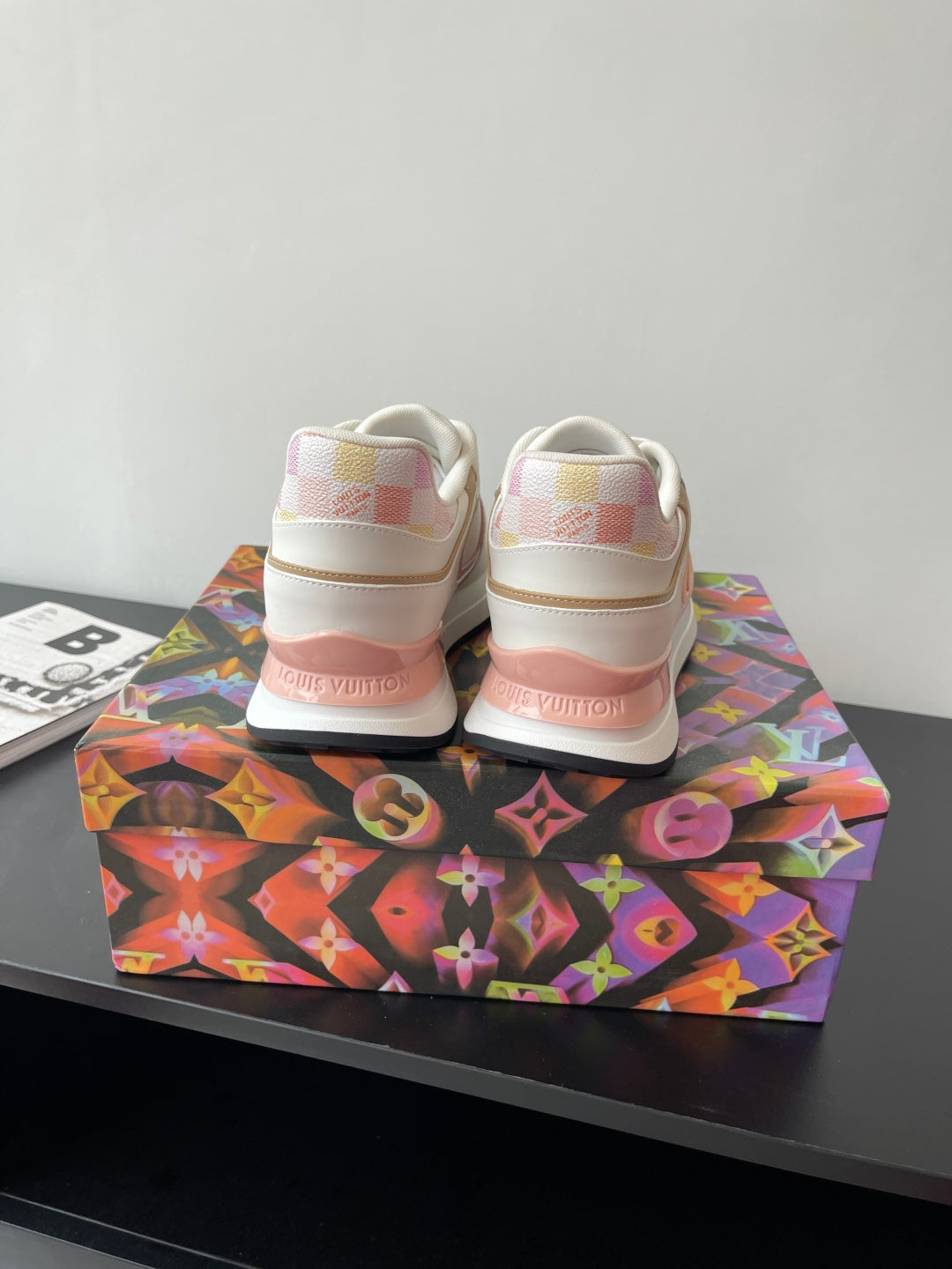 Louis Vuitton women's sneakers, rear view, white with pink heel accents, lace-up style
