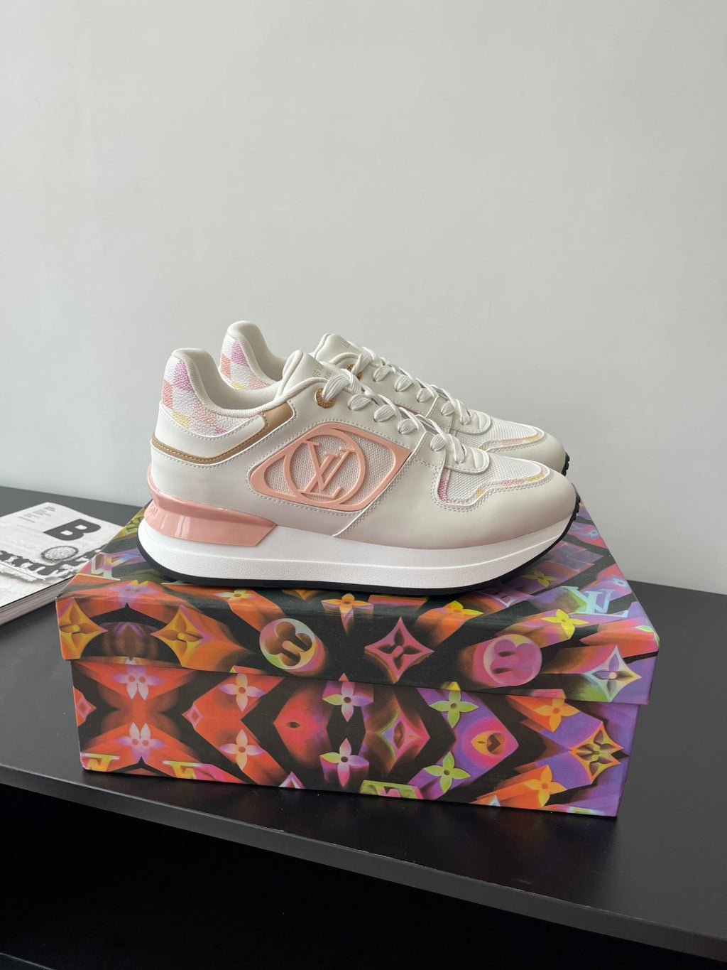 Louis Vuitton women's sneakers, side view, white with pink emblem, lace-up style