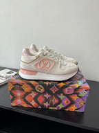 Louis Vuitton women's sneakers, side view, white with pink emblem, lace-up style