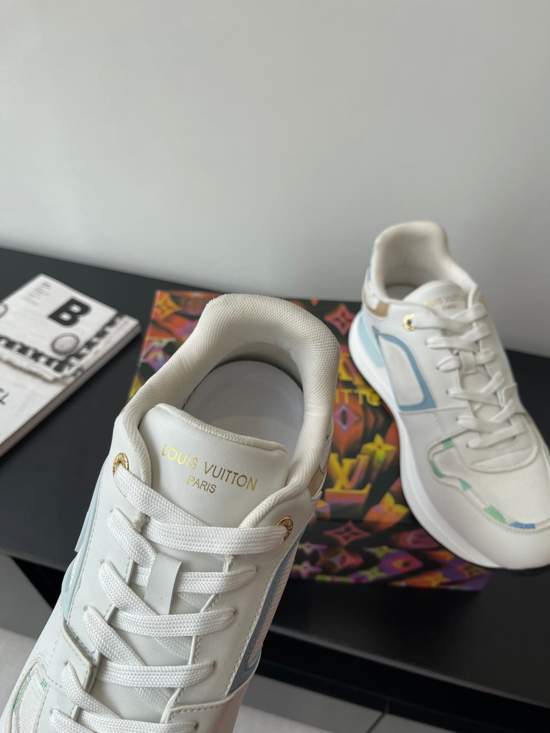 Louis Vuitton women's sneakers close-up, white upper with LV on the tongue
