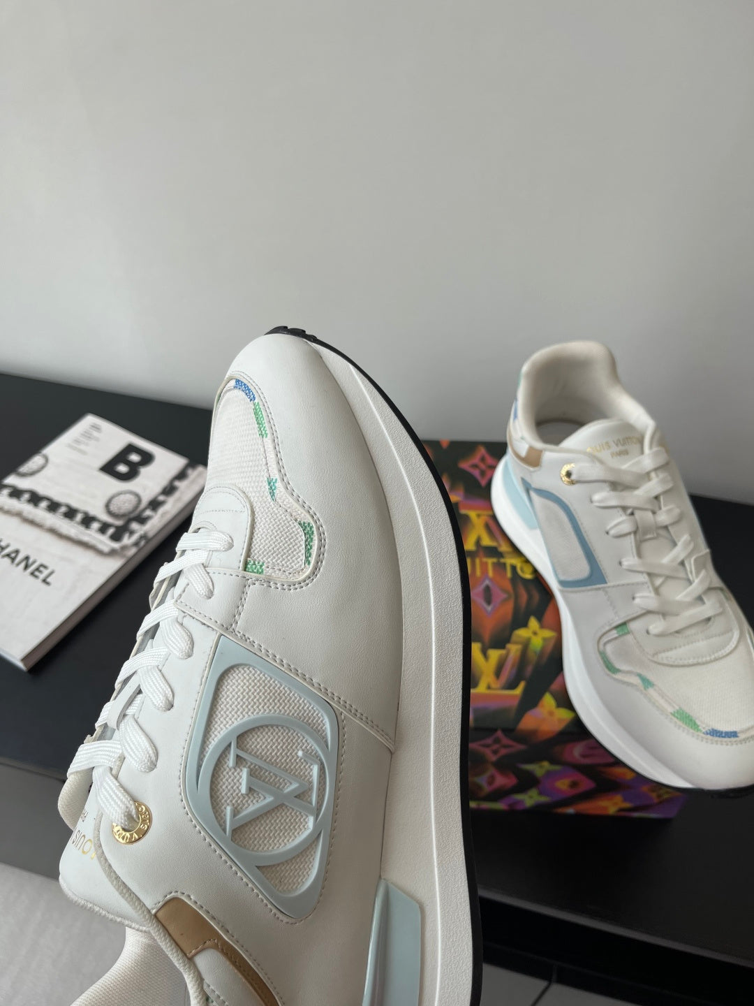 Louis Vuitton women's sneakers, white side panel with LV emblem and gold lace tag