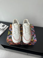 Women's Louis Vuitton sneakers, white with pink trim and lace-up front