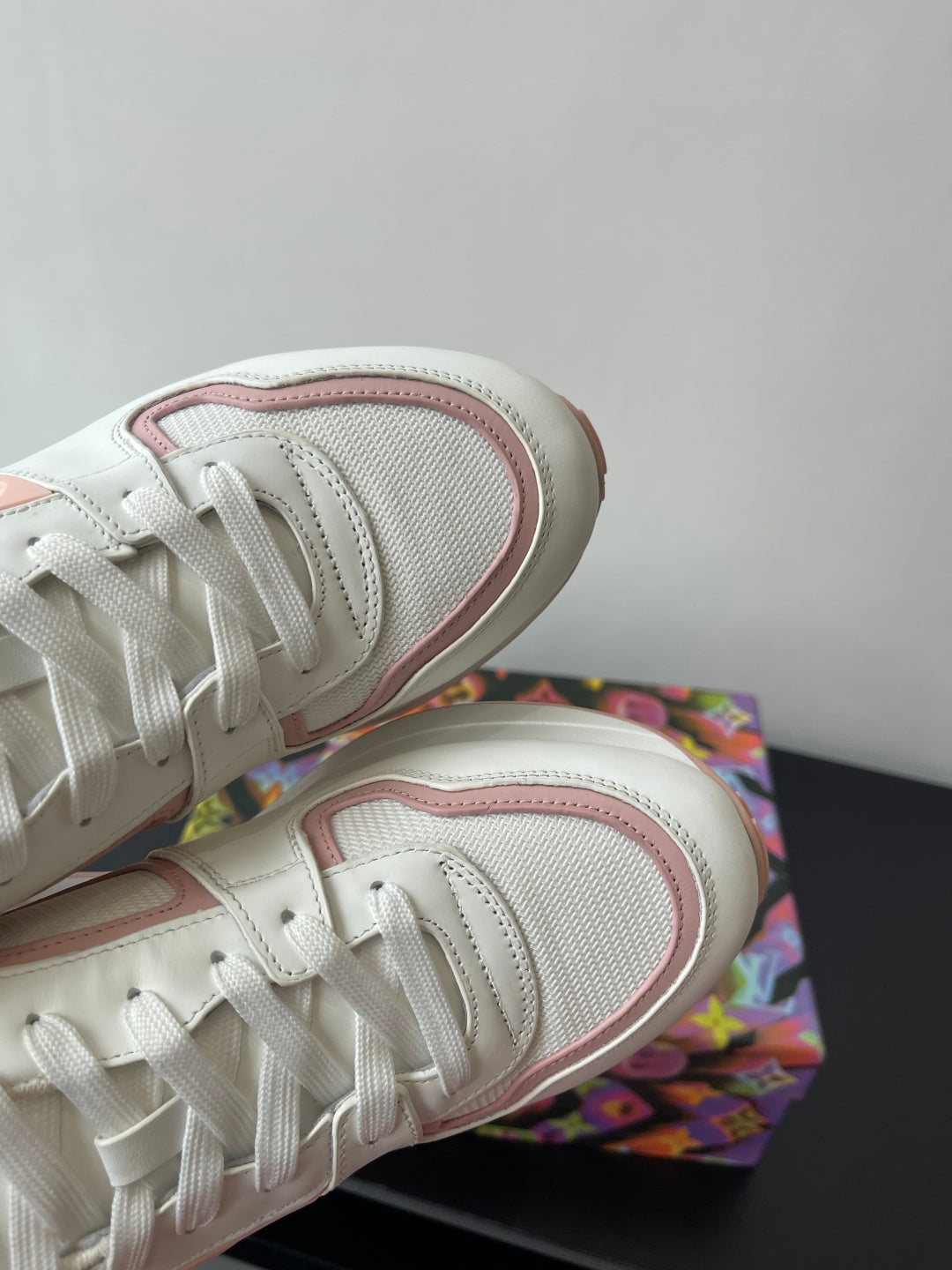 Women's Louis Vuitton sneakers close-up, white mesh side with pink-trimmed edge