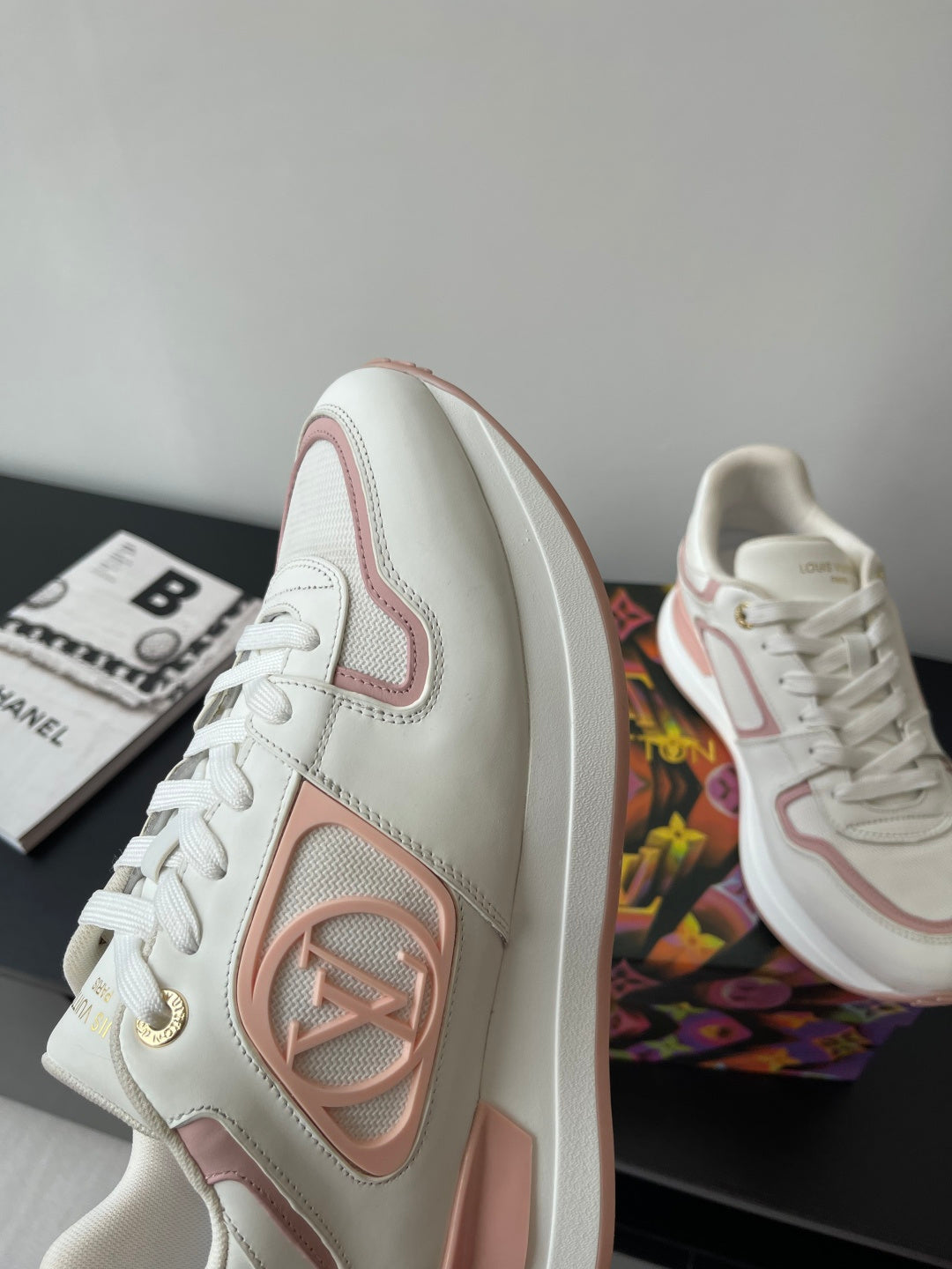 Women's Louis Vuitton sneakers, side and front view in white with pink trim