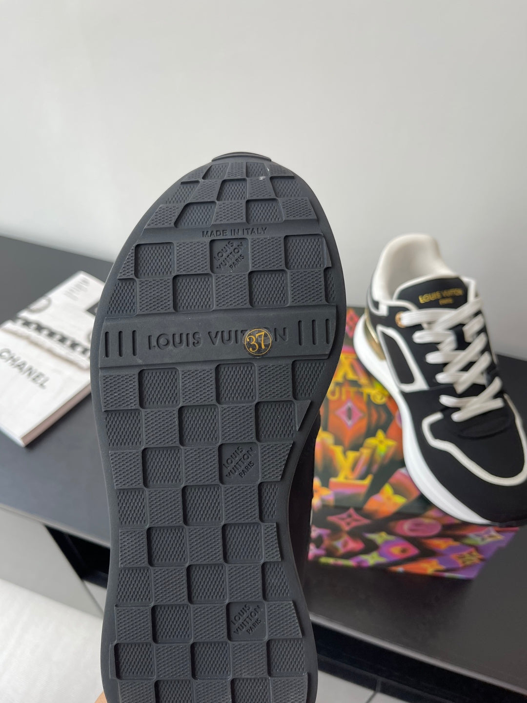 Ladies' Louis Vuitton sneakers outsole, dark tread with embossed Louis Vuitton text.