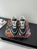 Ladies' Louis Vuitton sneakers, black with white laces and white logo trim, front view.