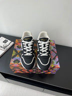Ladies' Louis Vuitton sneakers, black with white laces and white logo trim, front view.