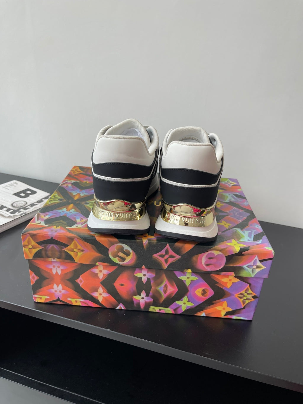 Ladies' Louis Vuitton sneakers back view, black with white trim and heel tabs.