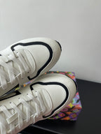 Close-up of white Louis Vuitton sneakers’ laces and black-trimmed collar