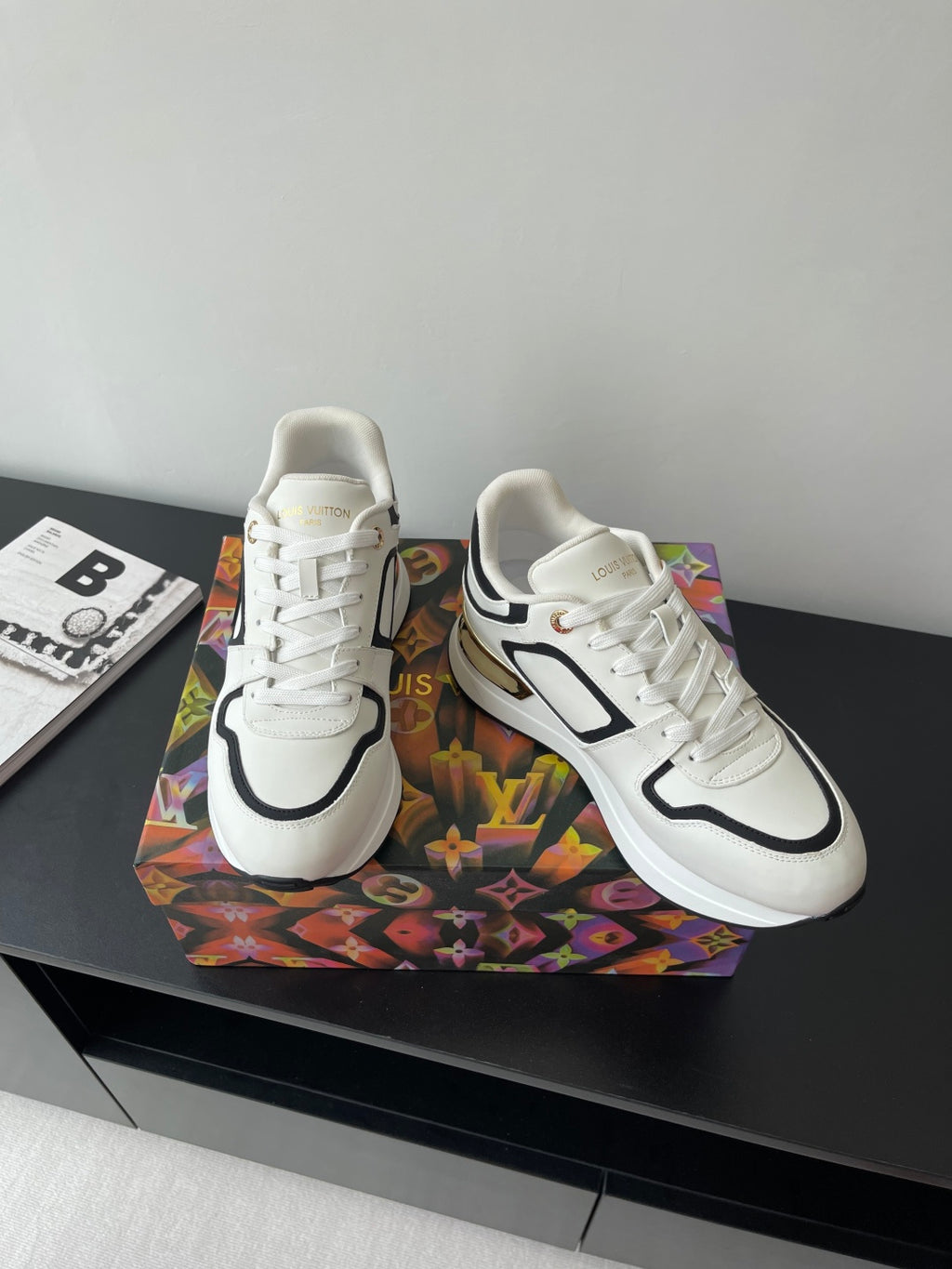 Pair of white Louis Vuitton women’s sneakers with black accents and white laces